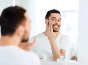 young-man-applying-face-cream